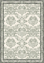 Green floral rug with damask pattern.